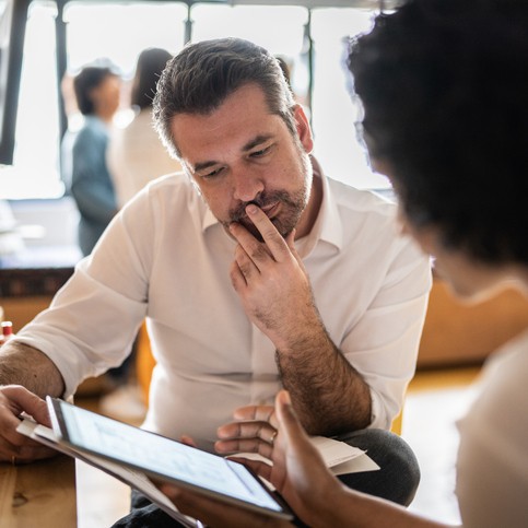 A small business owner talking with a workplace business adviser